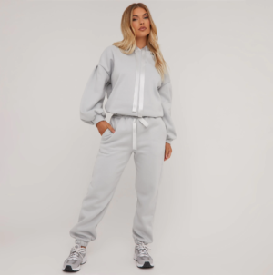 blonde lady wearing a grey hoodie and jogger set with ribbon drawstrings