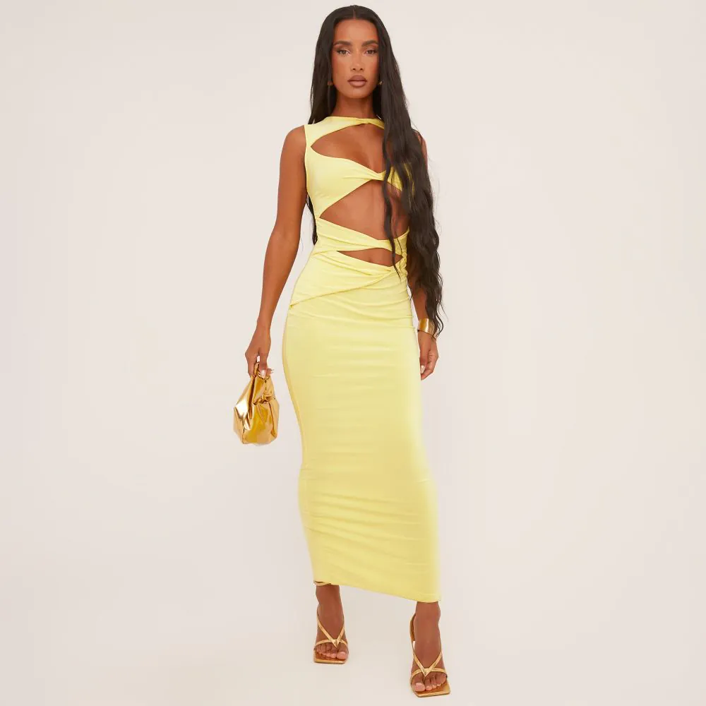 A yellow maxi dress with daring cut outs and three twist details on the front. The yellow dress has a bodycon fit and sleeveless style.